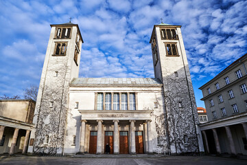 The facade of a modernist church with two bell towers in Poznan
