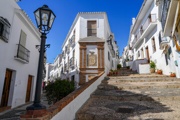 Fototapeta na wymiar Corner building and mosaic steps in Frigiliana Spain