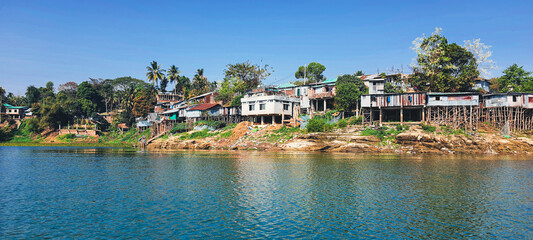 Fototapeta premium Rural house on silts hill tribe settlements along the coastline of Kaptai lake