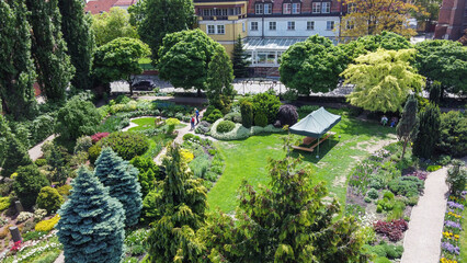 Amazing  drone point of   view on Wroclaw Botanical garden with flowerbeds and garden pathes: awe flowerbeds and topiary trees