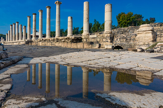 Numerous columns reflect in puddle in Bet She'an in Israel