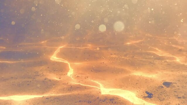 Underwater diving light rays and reflections, caustics and particles in clear shallow beach water. Beautiful vfx effect for video and movie overlay projects. 