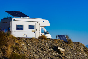 Obraz na płótnie Canvas Caravan with tilt solar panels on roof.