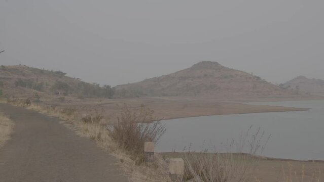 Slog 3 Footage of empty road nea river.