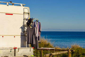 Caravan on beach with clothes to dry - 779216090