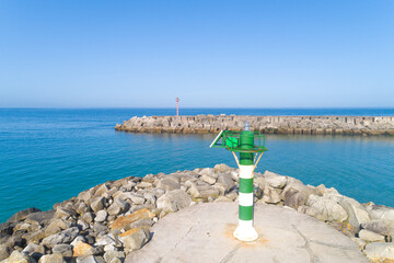 elevated view of the lanterns of a breakwater at the entrance of a port - obrazy, fototapety, plakaty