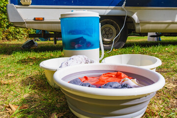 Washing laundry outdoor at caravan - 779216607