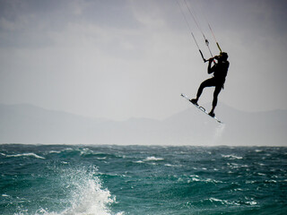 Kite surfer riding waves. Kiteboarding sport. - 779216887