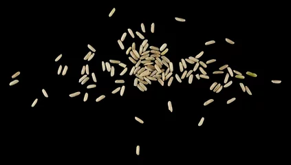 Deurstickers Brown long rice, uncooked and hulled, isolated on black, top view © dule964