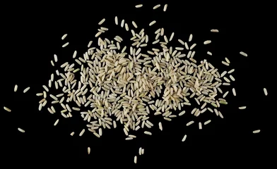 Fotobehang Brown long rice, uncooked and hulled, isolated on black, top view © dule964