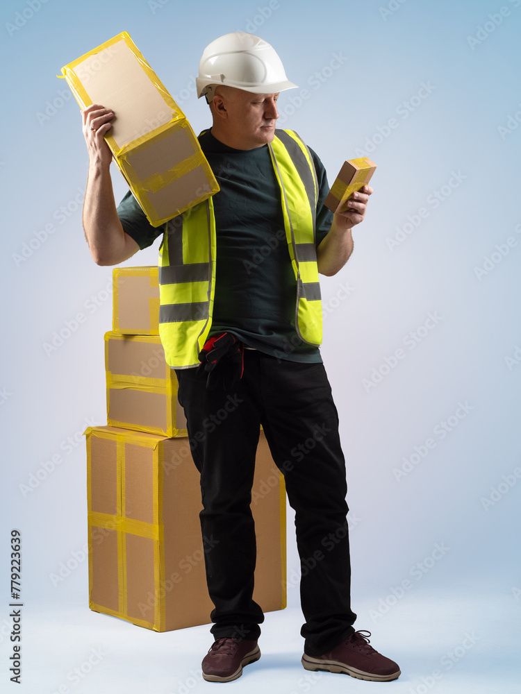 Poster man loader with boxes. guy working as sorter in warehouse. loader with parcels of different sizes. d