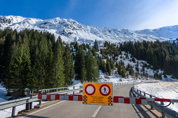 Barrier on the road of the Lukmanier mountain pass in Switzerland - danger of avalanches