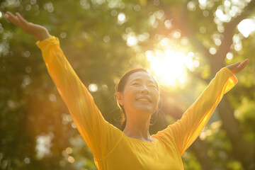 Young Asian woman in yellow outfit smiling arms open.
Happiness, enjoying life.