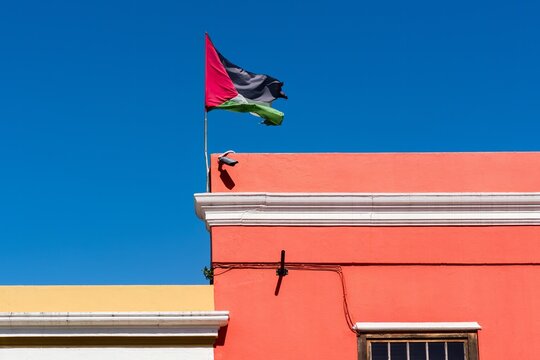 Palestine flag waving against clean blue sky