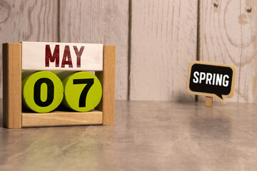 7 Mai on wooden grey cubes. Calendar cube date 07 May. Concept of date.