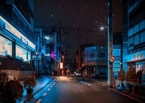 Seoul, South Korea - February 24, 2024: Seoul street with night bars during a snowfall