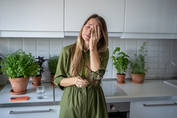 Tired sad woman rubbing eyes. Female depressed, dispirited, mournful, stressed, going through...