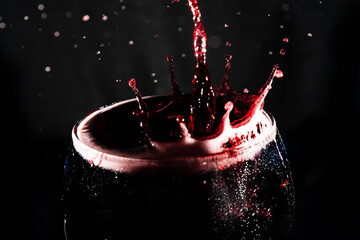 Close-up of the top of a clear glass goblet filled with wine with splashes of water. Splash Effect.