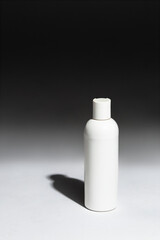 Blank bottle in a studio with a shadow. 