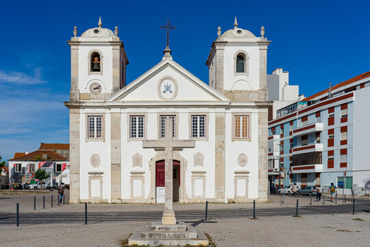 Front Facade of Sra do Rosario Church with Stone Crucifix in Foreground,Barreiro-Portugal.04-04-2024