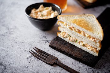 Egg tuna salad sandwich on a dark background