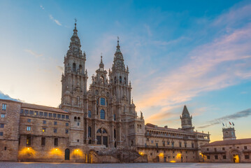 Santiago de Compostela Cathedral at sunrise with main square Praza do Obradoiro, Galicia, Spain. Galician gothic church. Popular touristic landmark with no people - obrazy, fototapety, plakaty