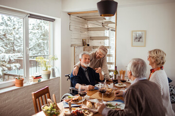 Diverse senior people eating lunch together at home