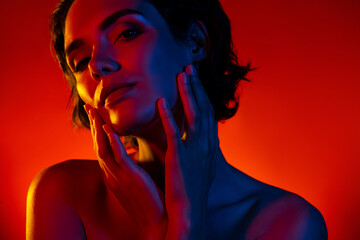 Photo of pretty sweet woman naked shoulders arms applying lifting cream empty space isolated red neon color background - obrazy, fototapety, plakaty