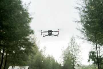 An unmanned aerial vehicle or quadcopter drone that flies with four rotors