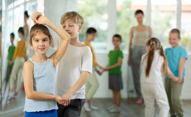 Couple boy and girl dancing ballroom waltz dance in studio