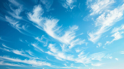 The ethereal beauty of wispy cirrus clouds streaking across a clear, blue sky.