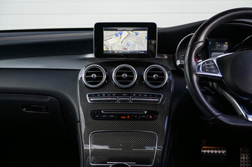Close-Up of Car Dashboard Design and Controls with Carbon Fibre and Navigation
