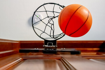 Selective focus on the netting of a miniature toy basketball hoop on the door of a bedroom.  - Powered by Adobe