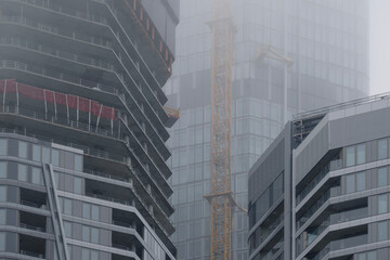 skyscrapers buildings disappear into the mist, creating mysterious and atmospheric urban landscape...