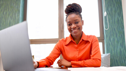 Portrait of a happy woman working online