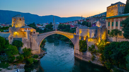 Sunset view of the old Mostar bridge in Bosnia and Herzegovina - obrazy, fototapety, plakaty