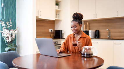 Happy African American woman freelancing