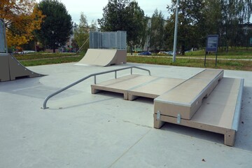 Children's playground in the skatepark for skateboarders and roller skates consisting of miniramp,...