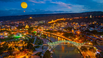 Sunset view of Narikala fortress and the Bridge of Peace in Tbilisi, Georgia © dudlajzov