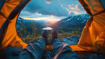 Traveler man relaxing and taking the view of a sunset inside a tent - obrazy, fototapety, plakaty