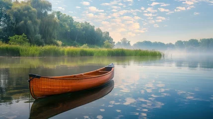 Foto op Canvas A canoe glides peacefully on the tranquil waters. © Firuz