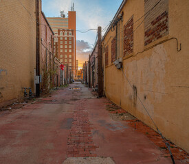 Evening view of setting sun in a back alley in downtown Lubbock, Texas, USA