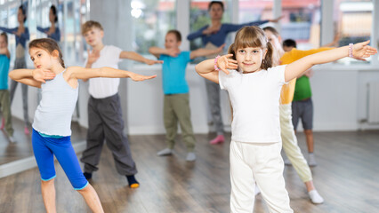 Dance class for kids, positive girls and boys training in dance studio