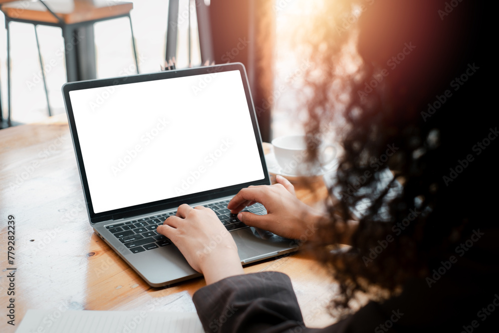 Poster close-up back view of a business woman working in the office typing, looking at the screen. office w