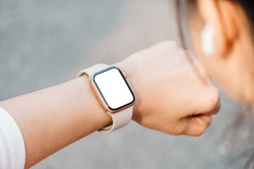 Close-up of a person wrist wearing a modern smartwatch with a blank screen, indicating connectivity...