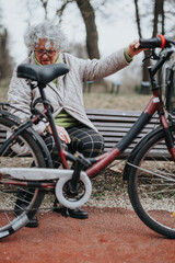 Fototapeta na wymiar Joyful mature female retiree enjoying outdoor activities, taking a rest with her bike in a park setting.