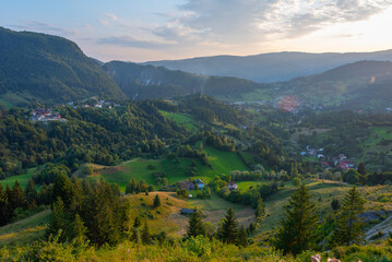 Sunset view of a village in a valley in Transylvania, Romania