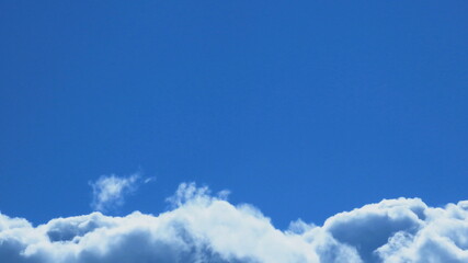 White clouds rising in the clear blue sky