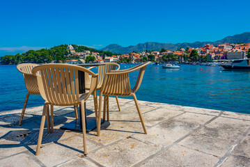 Cafe table and chairs at Croatian seaside at Cavtat - obrazy, fototapety, plakaty