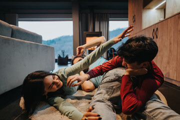 Group of friends lying down on the floor, enjoying a break and casual interaction in a cozy home setting.